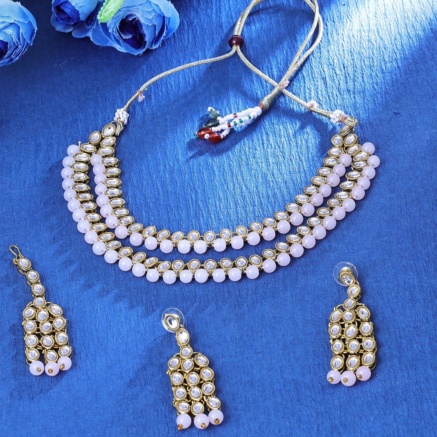 Sukkhi Striking Gold Plated Light Pink Artificial Stone Collar Necklace Set With Maang Tikka for Women