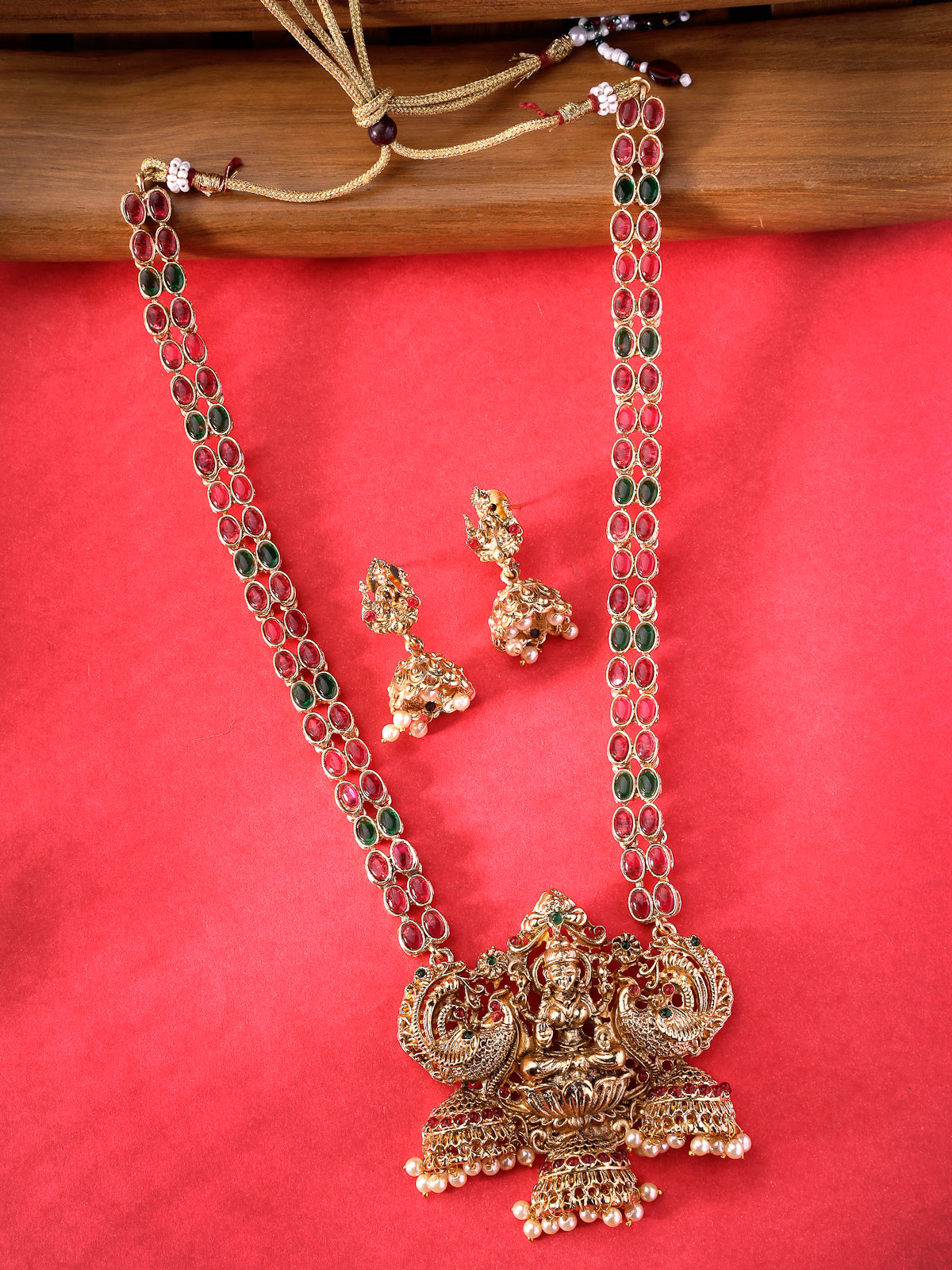 Sukkhi Classic-Inspired Gold Plated Red Green AD Stones Studded Long Temple Gold Haram Designs Necklace Set with Jhumki/Jhumka Earrings Jewellery Set For Women & Girls|NS106089