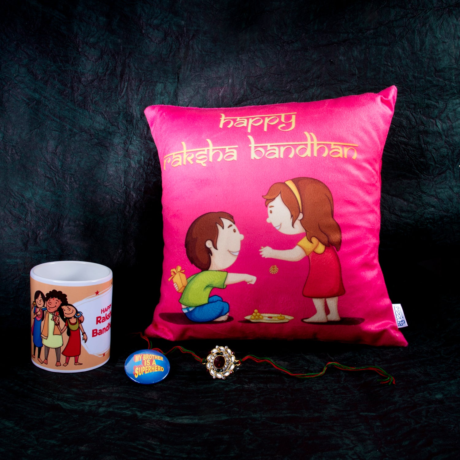 Sukkhi Raksha Bandhan Gifts Gold Plated Rakhi with Roli Chawal & Raksha Bandhan Greeting Card, Printed Cushion Cover Without Filler, Coffee Mug & My Brother is a Superhero Badge Combo for Brother
