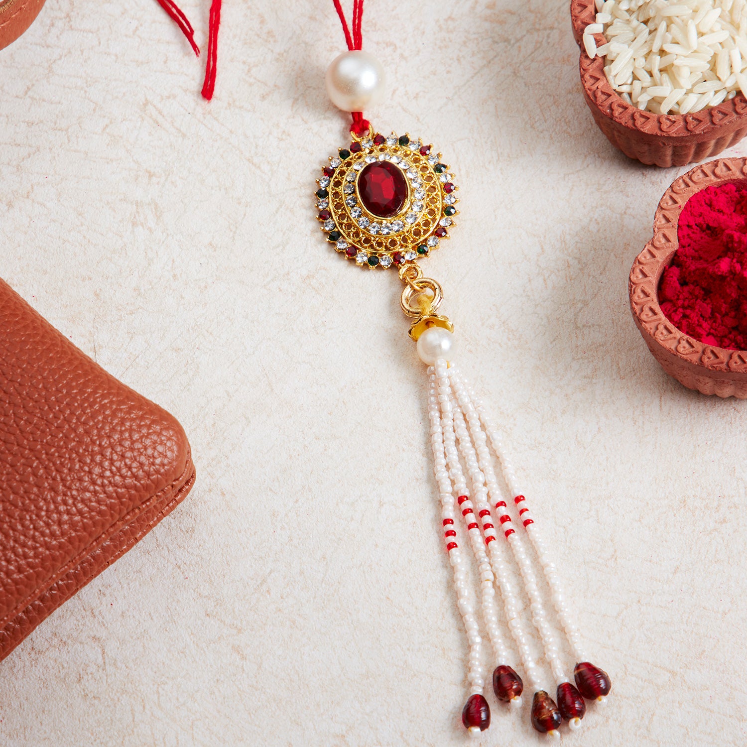 Sukkhi Elegant Gold Plated Bhaiya Bhabhi Rakhi Lumba Set with Roli Chawal and Raksha Bandhan Greeting Card