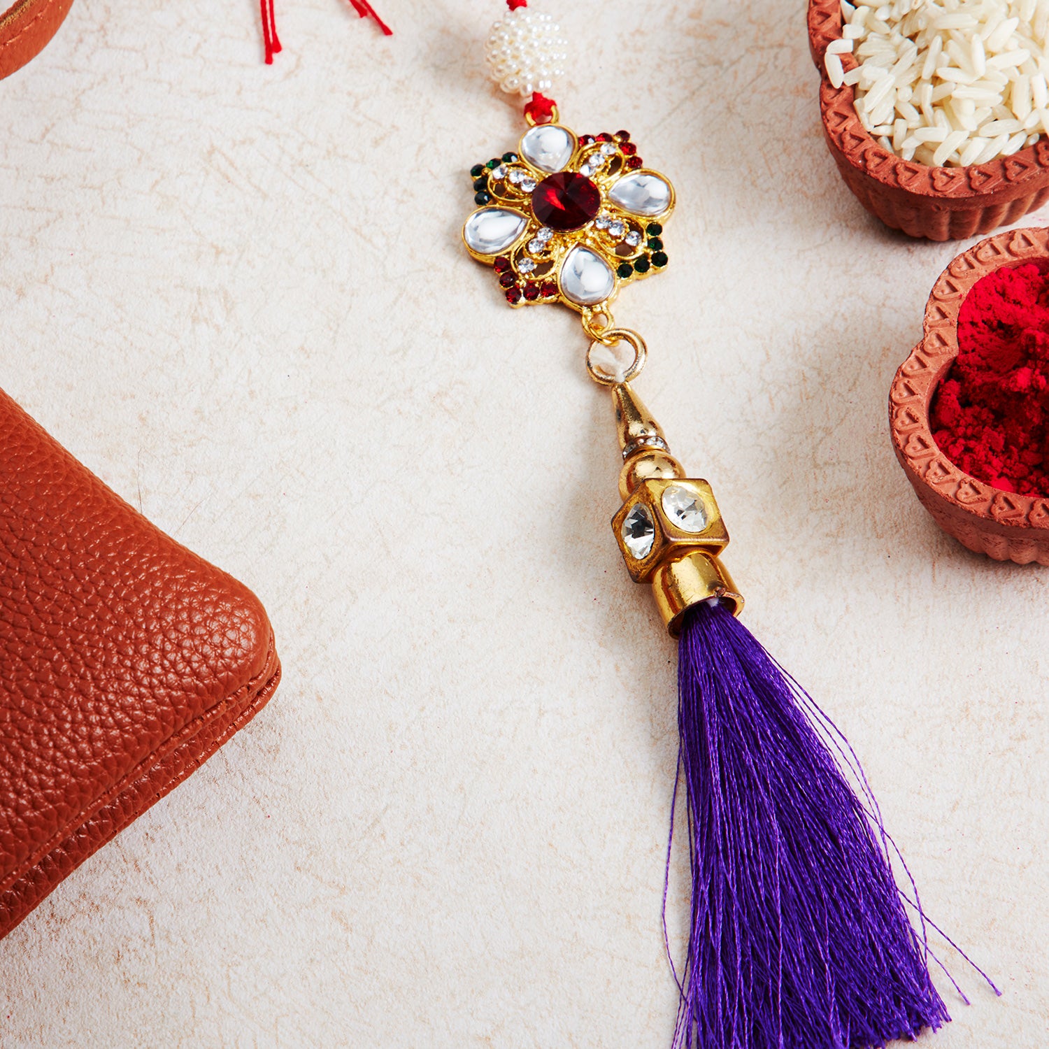 Sukkhi Glorious Gold Plated Bhaiya Bhabhi Rakhi Lumba Set with Roli Chawal and Raksha Bandhan Greeting Card