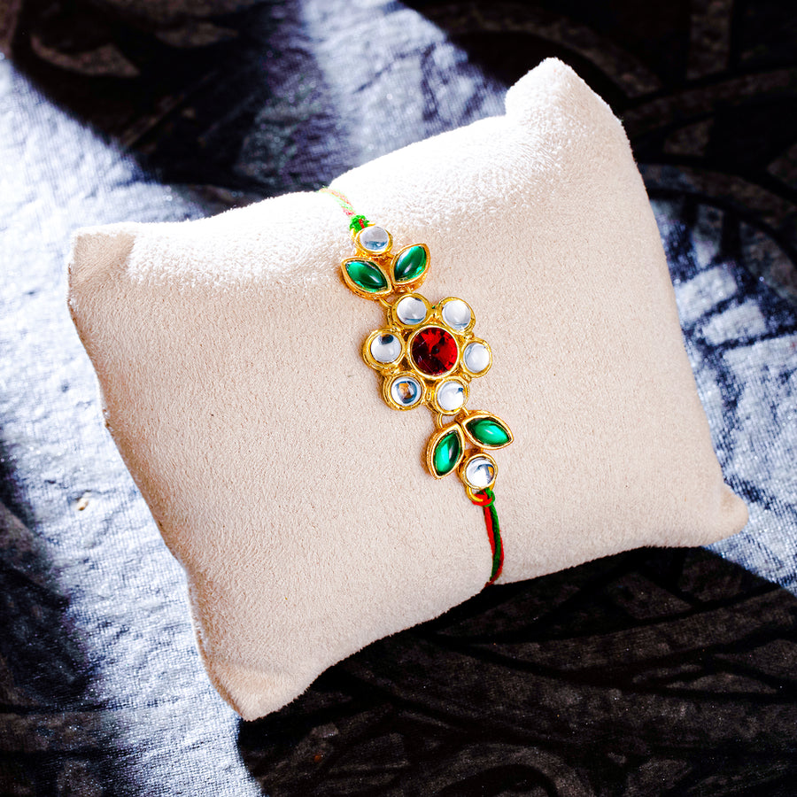 Sukkhi Delightful Gold Plated Floral Rakhi with Roli Chawal and Raksha Bandhan Greeting Card For Men
