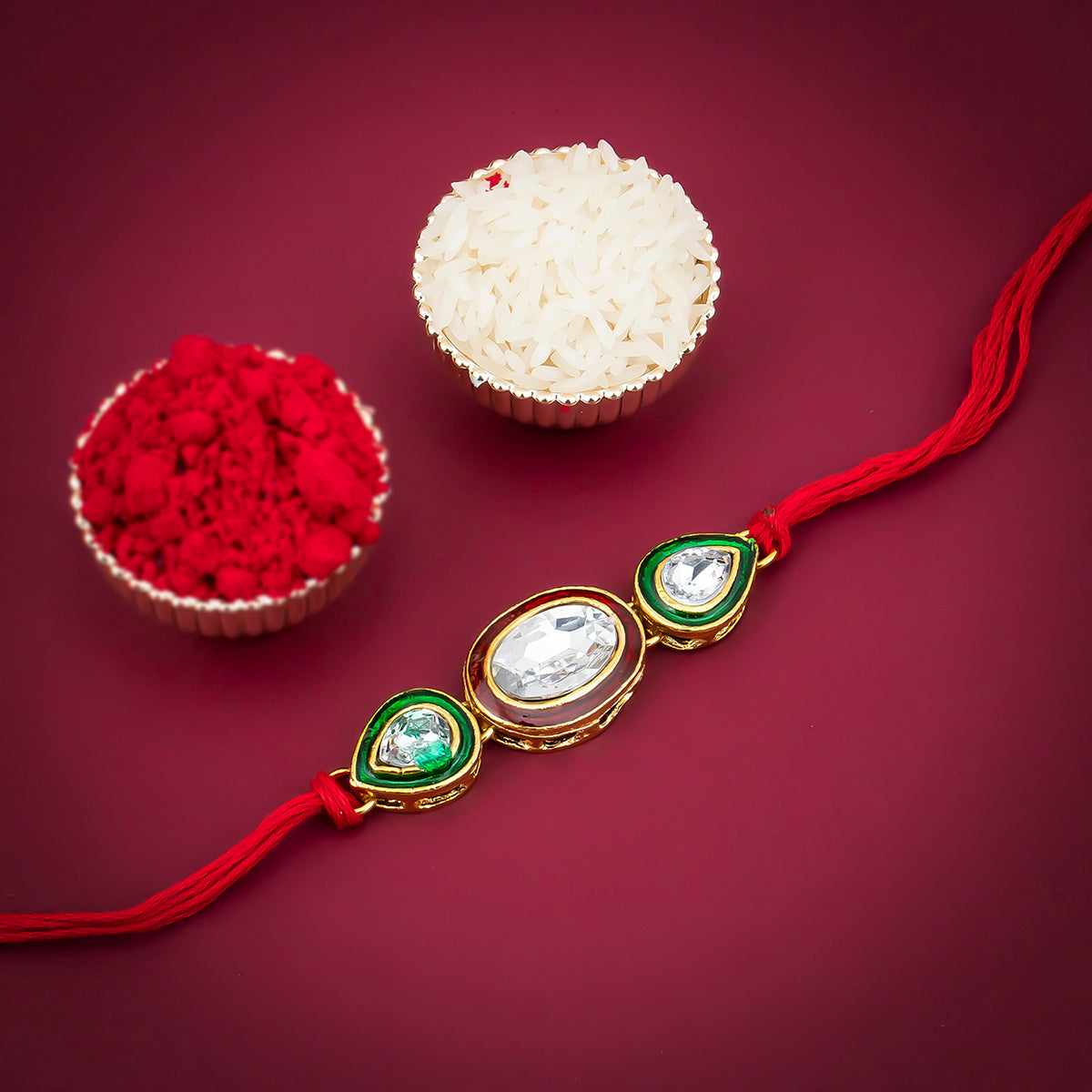 Sukkhi Gleaming Gold Plated Oval Meenakari Rakhi with Roli Chawal and Raksha Bandhan Greeting Card For Men