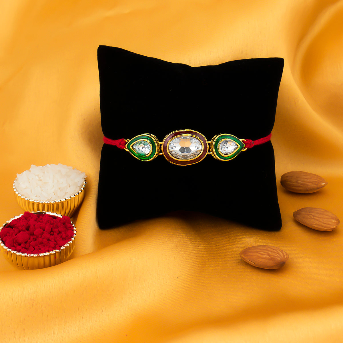 Sukkhi Gleaming Gold Plated Oval Meenakari Rakhi with Roli Chawal and Raksha Bandhan Greeting Card For Men