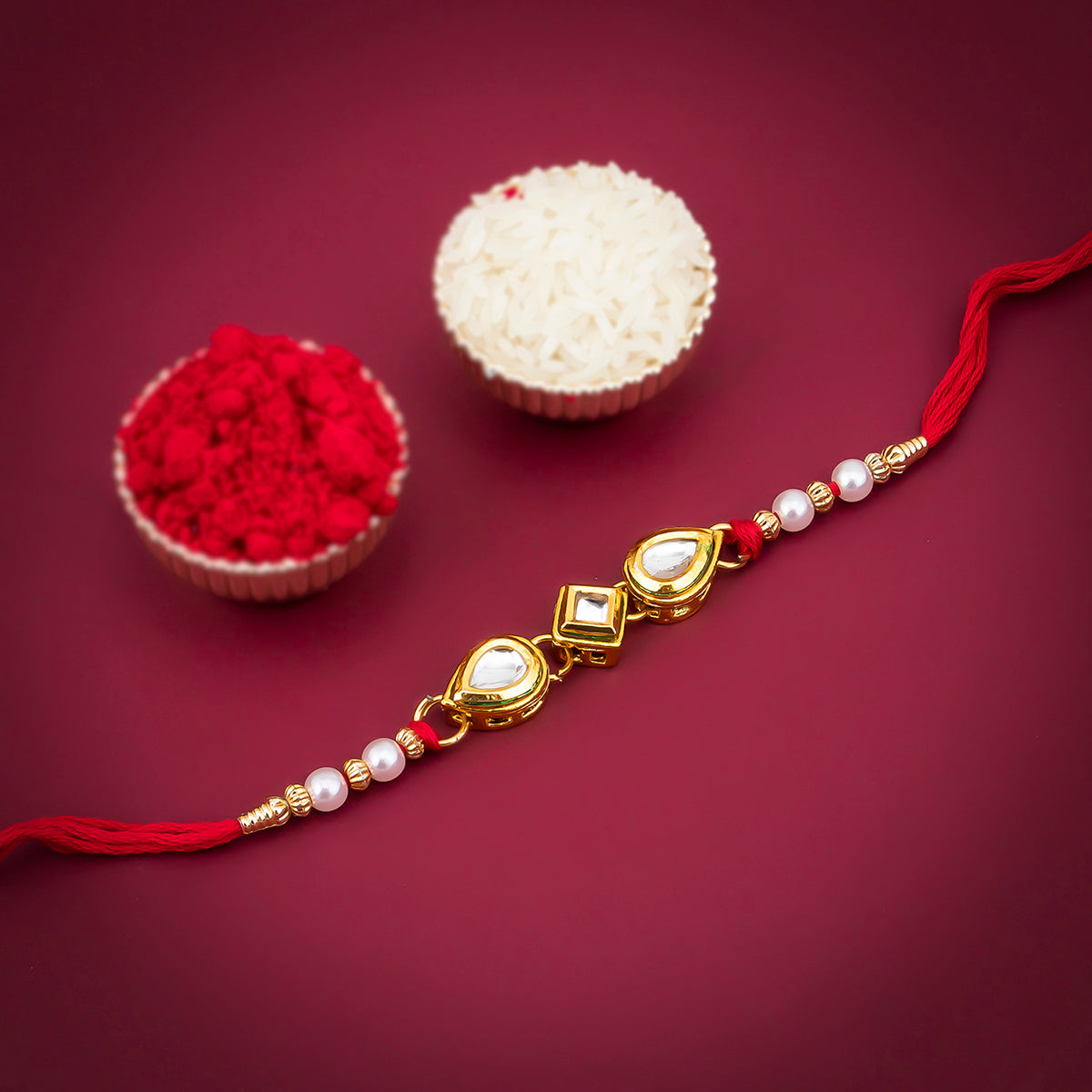 Sukkhi Finely Gold Plated Kundan and Pearl Rakhi with Roli Chawal and Raksha Bandhan Greeting Card For Men