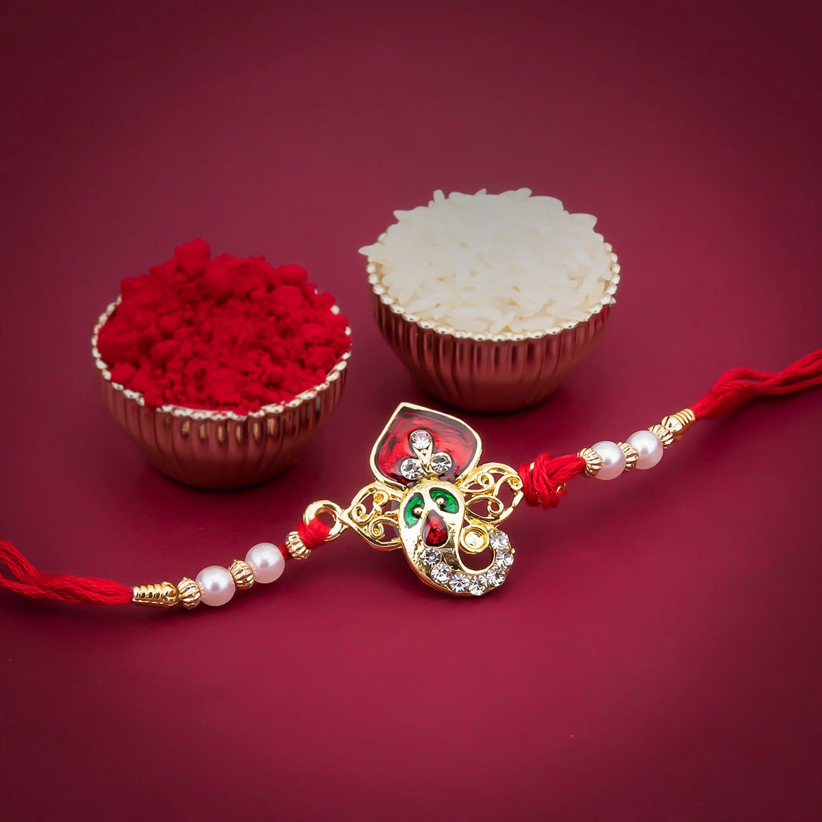 Sukkhi Fabulous Gold Plated Meenakari Ganesh Rakhi with Roli Chawal and Raksha Bandhan Greeting Card For Men