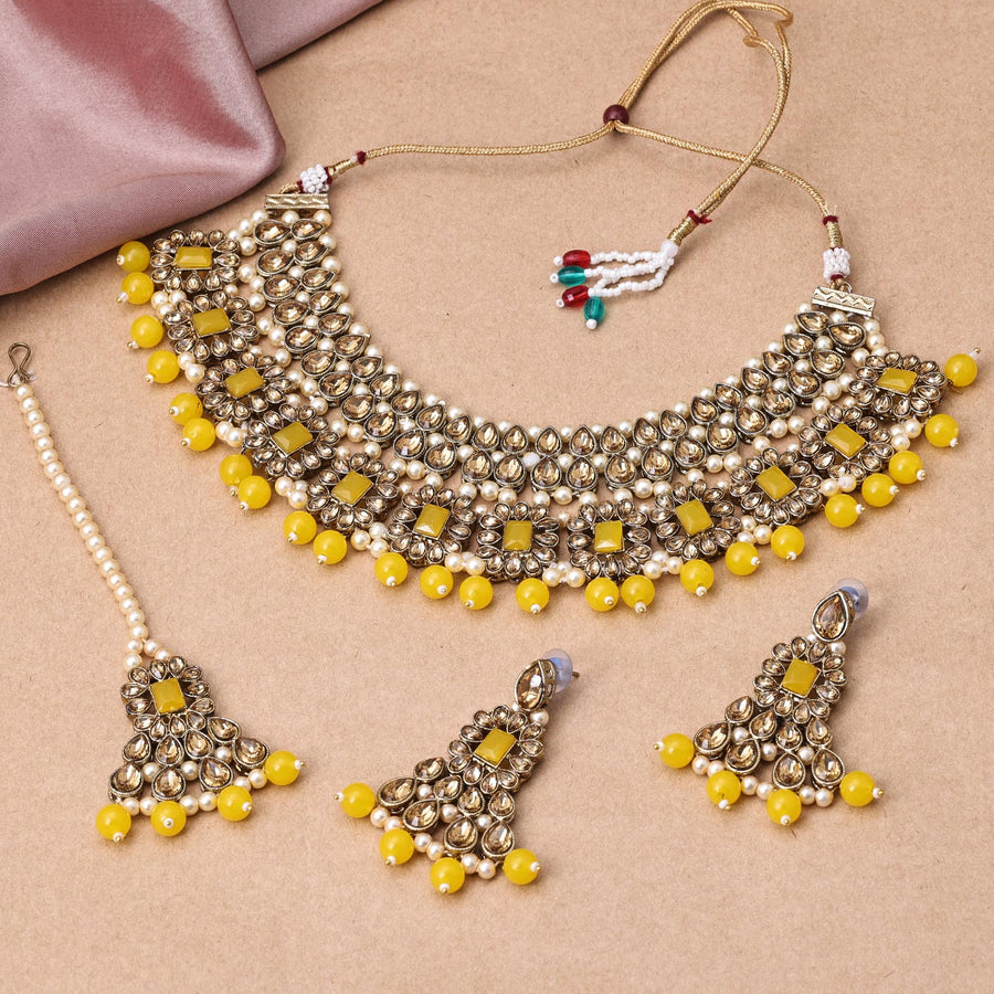Sukkhi Gleaming Gold Plated Reverse AD & Pearl Yellow Necklace Set for Women