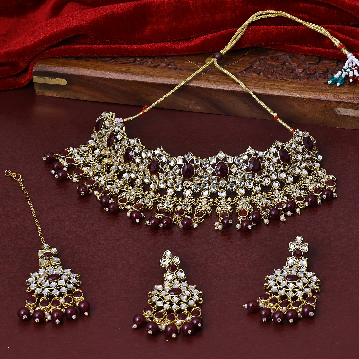 Sukkhi Good Gold Plated Maroon Color Stone Collar Necklace Set With Maang Tikka for Women