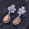 Sukkhi Lovesome Peach CZ Stone Rhodium Plated Dangler Earrings for Women