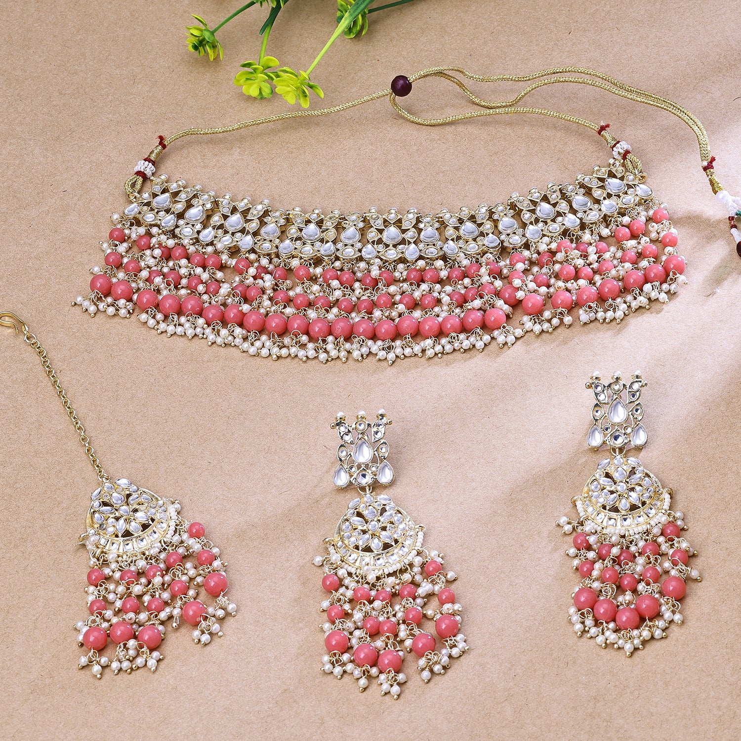 Sukkhi Hypnotizing Light Pink Austrian Stone Gold Plated Traditional Necklace Set With Maang Tikka for Women