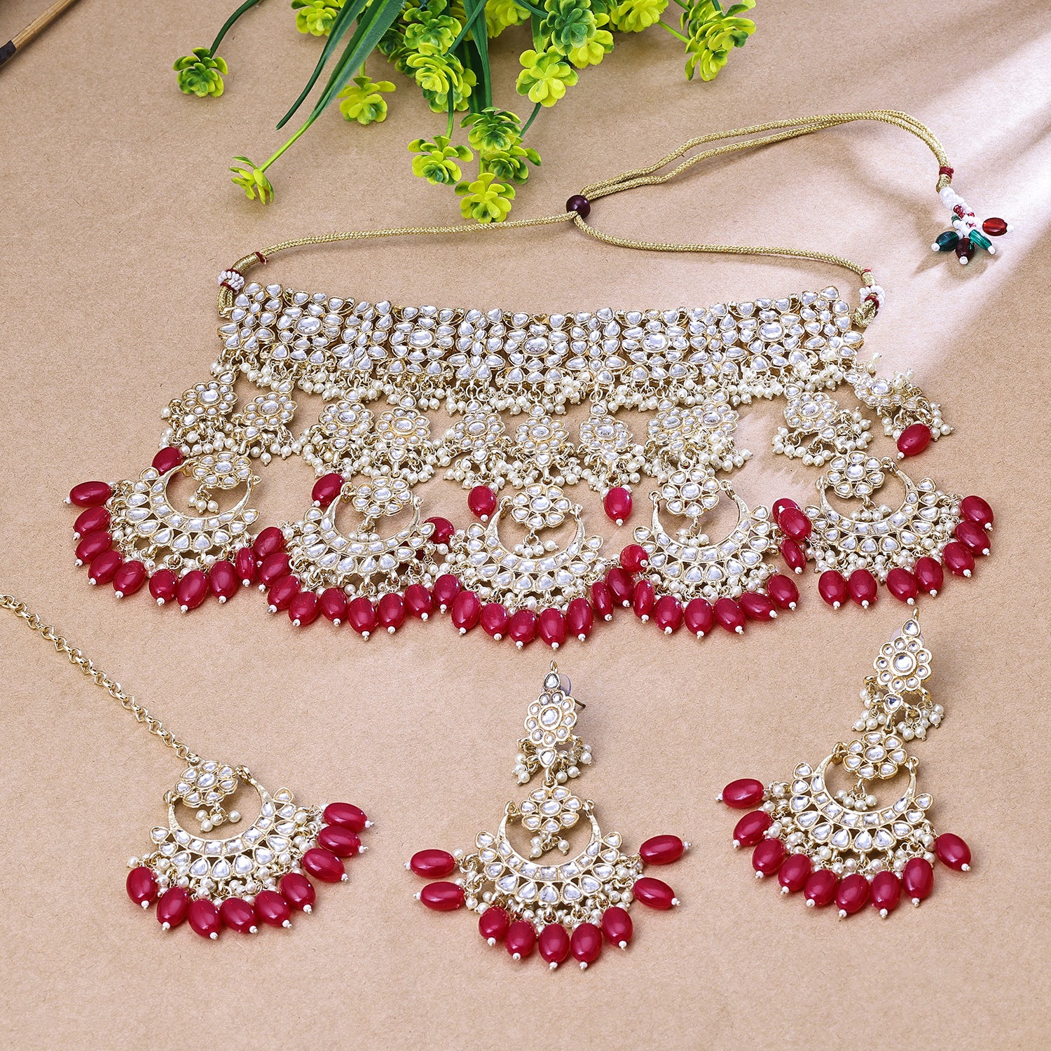 Sukkhi Tempting Red And Golden Austrian Stone Gold Plated Traditional Necklace Set With Maang Tikka for Women